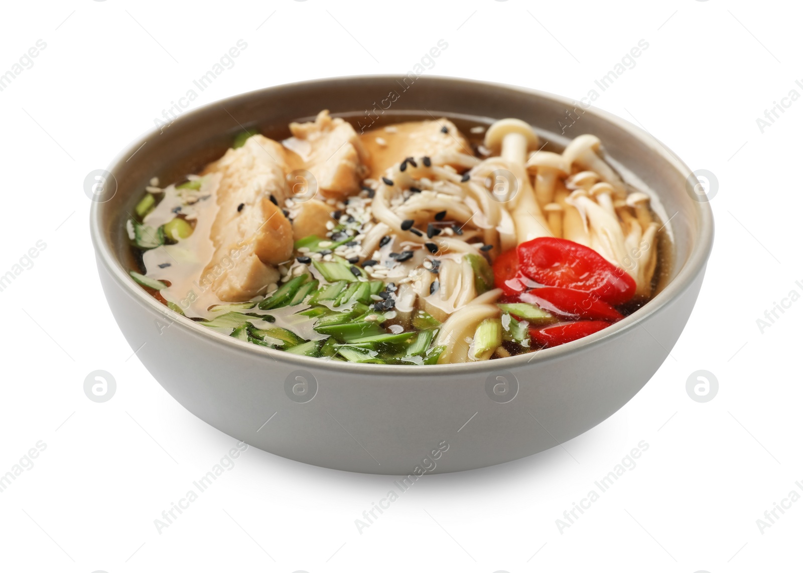 Photo of Delicious ramen with meat and mushrooms in bowl isolated on white. Noodle soup