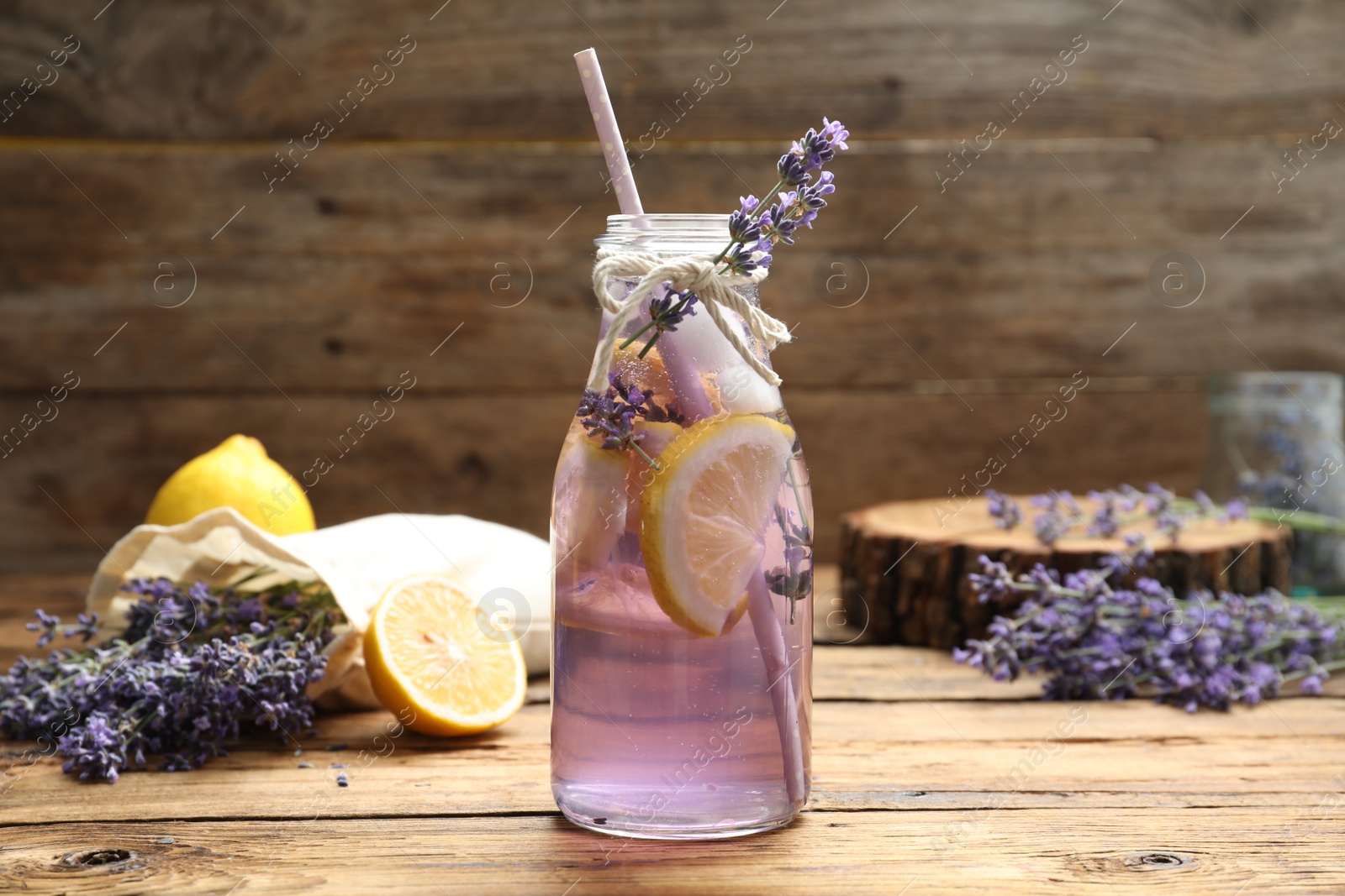 Photo of Fresh delicious lemonade with lavender on wooden table