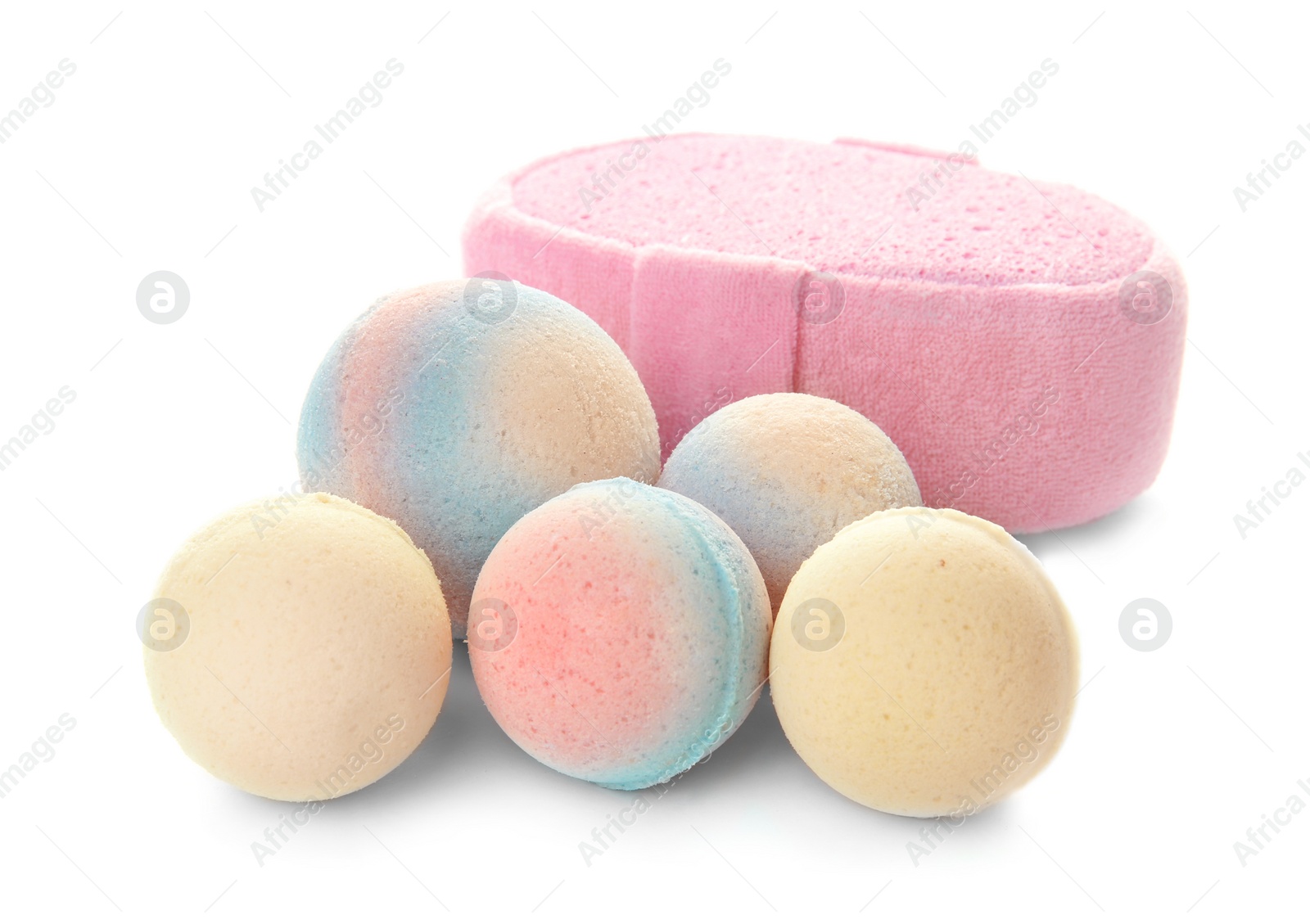 Photo of Pink sponge and bath bombs on white background