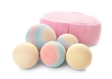 Photo of Pink sponge and bath bombs on white background