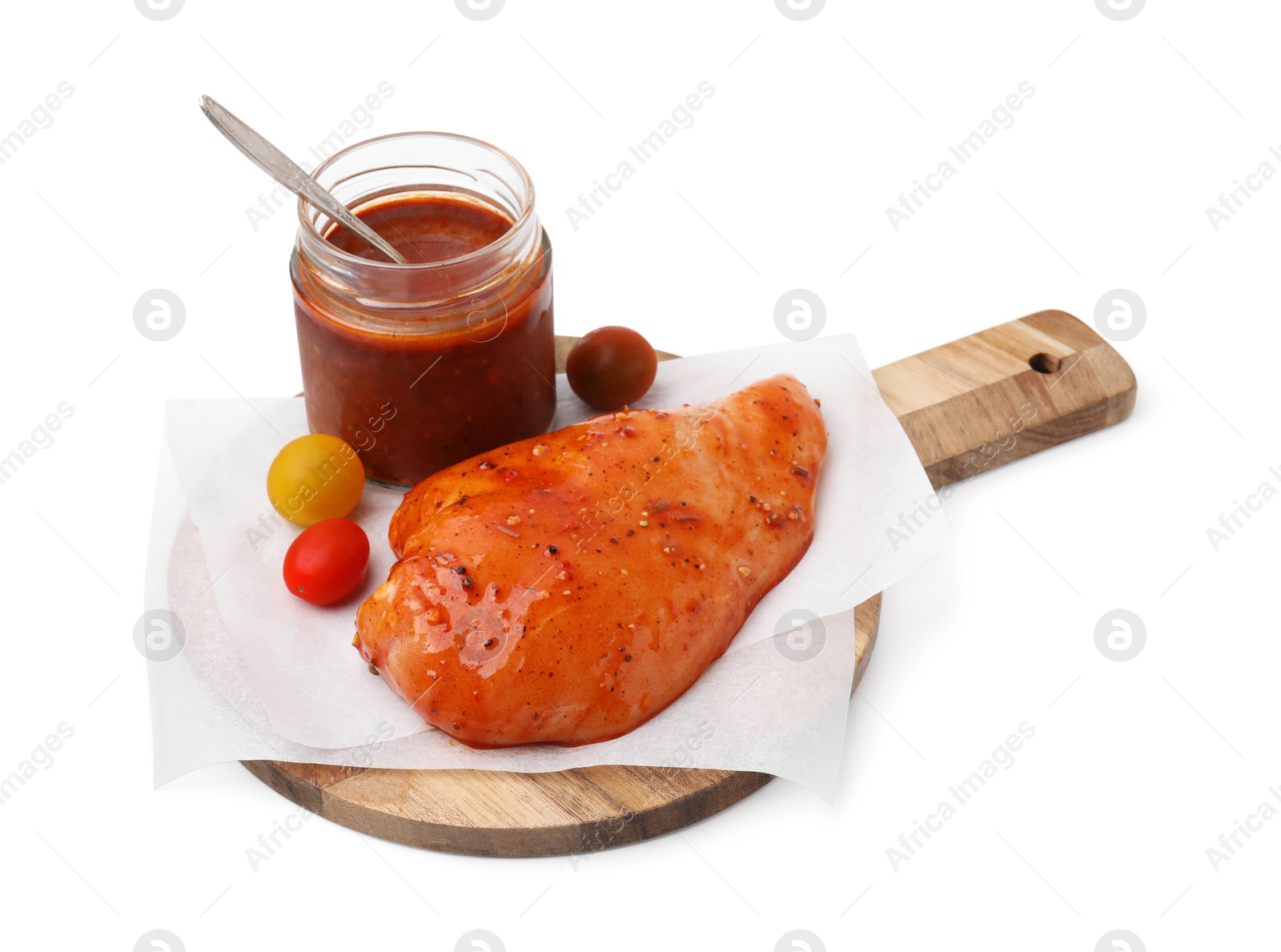 Photo of Fresh marinade and raw chicken fillets isolated on white
