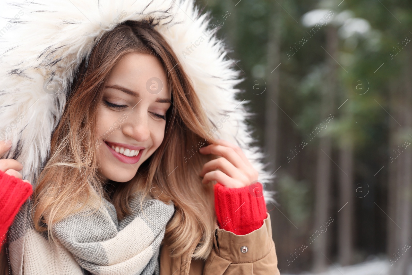 Photo of Young woman in warm clothes outdoors, space for text. Winter vacation