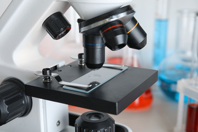 Image of Microscope with glass slide on table, closeup. Laboratory analysis