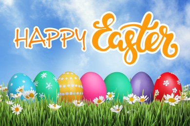 Image of Happy Easter. Bright eggs and spring flowers on green grass outdoors