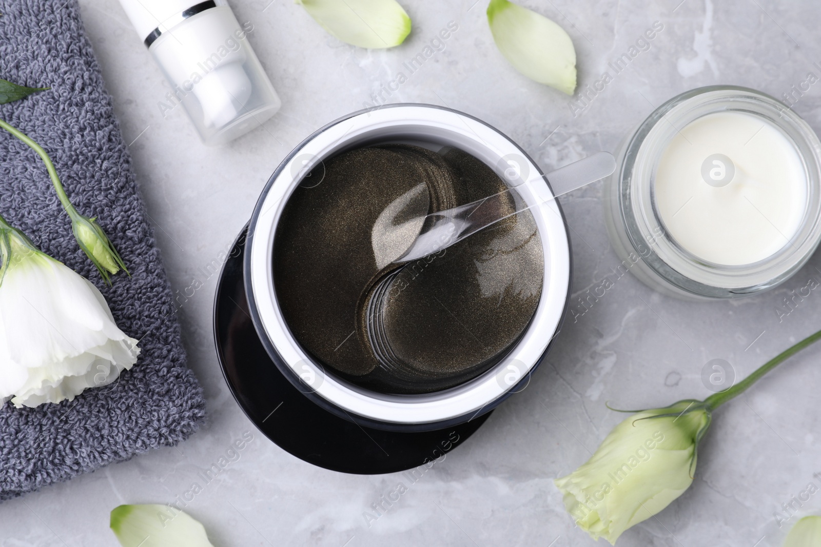 Photo of Flat lay composition with under eye patches on light grey marble table. Cosmetic product