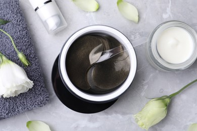 Flat lay composition with under eye patches on light grey marble table. Cosmetic product