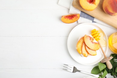 Photo of Delicious peach dessert on white wooden table, flat lay. Space for text