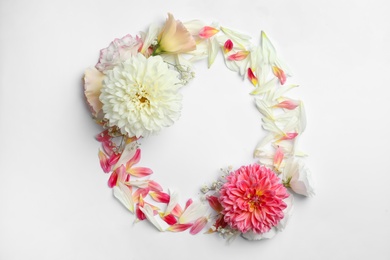 Frame made with beautiful dahlia and eustoma flowers on white background, flat lay. Space for text