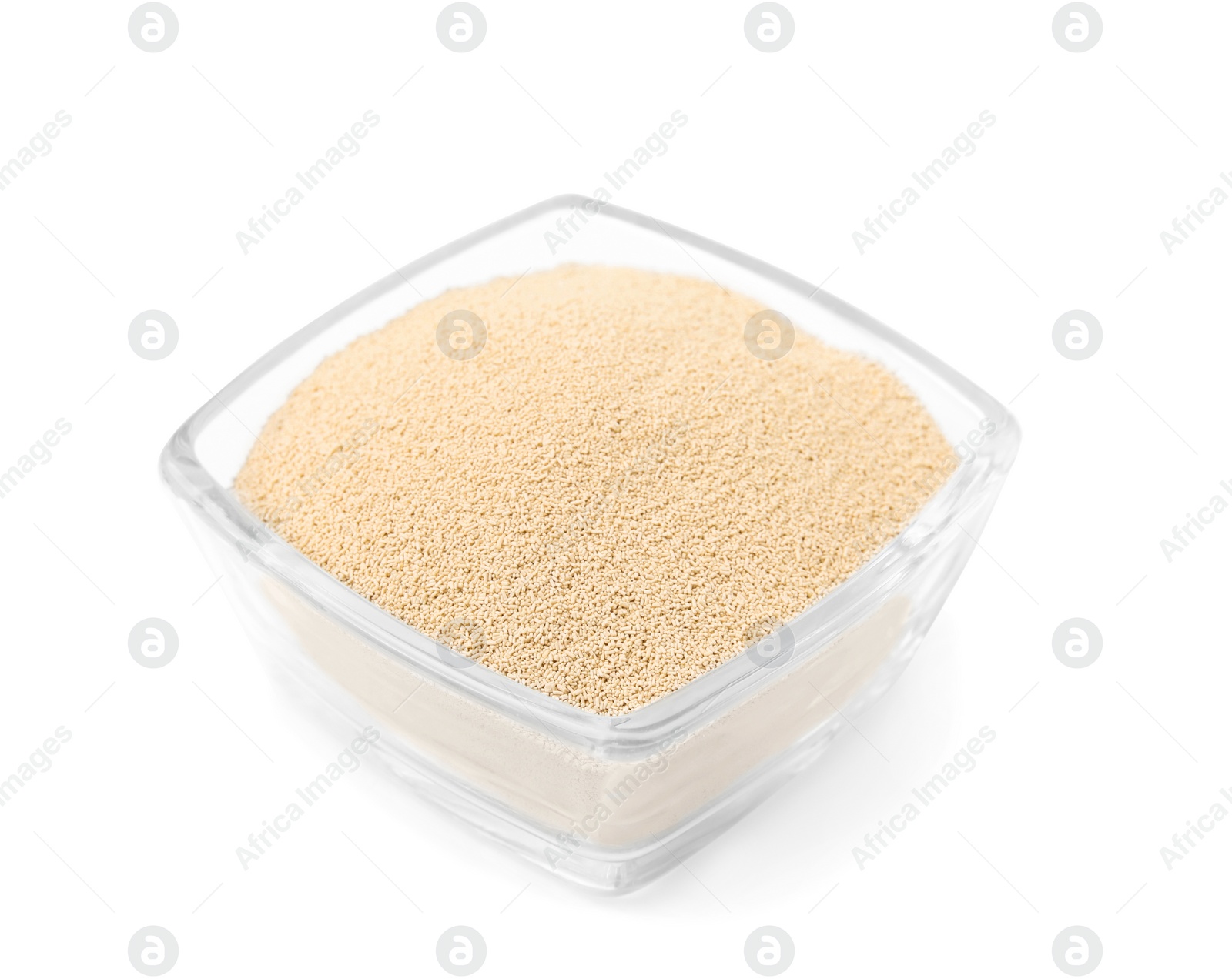 Photo of Granulated yeast in glass bowl isolated on white