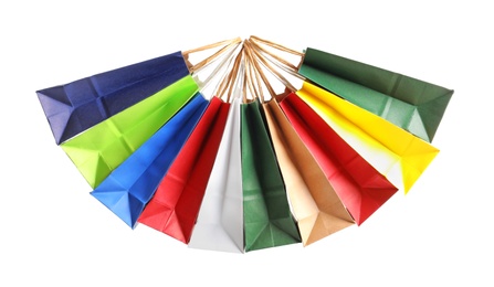 Photo of Colorful paper shopping bags on white background