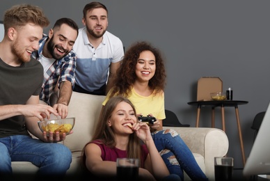 Photo of Emotional friends playing video games at home