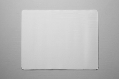 Photo of One mouse pad on grey background, top view. Space for text