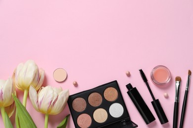 Photo of Flat lay composition with different makeup products and beautiful tulips on pink background. Space for text