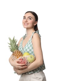 Photo of Woman with string bag of fresh fruits on white background