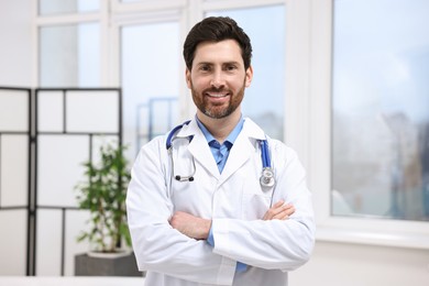 Photo of Portrait of medical consultant with stethoscope in clinic