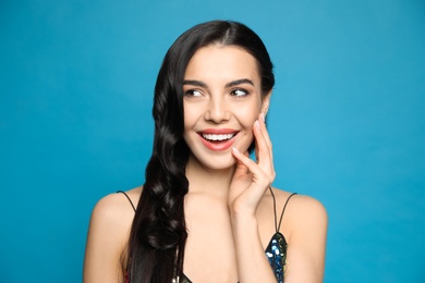 Photo of Portrait of surprised woman on blue background