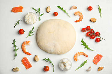 Photo of Flat lay composition with dough and fresh ingredients for seafood pizza on white table