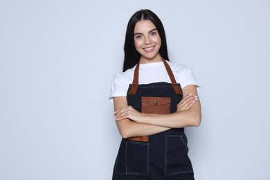 Photo of Portrait of happy hairdresser on light background