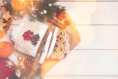 Beautiful composition with Christmas Stollen and space for text on white wooden table, flat lay. Bokeh effect
