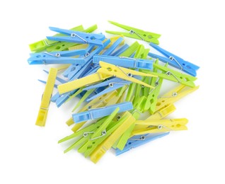 Photo of Colorful plastic clothespins on white background, top view