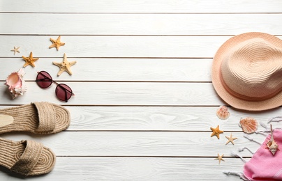 Photo of Beach accessories on white wooden background, flat lay. Space for text