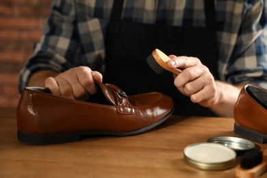 Photo of Master taking care of shoes in his workshop, closeup