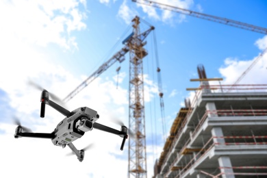 Image of Modern drone flying at building site. Aerial survey