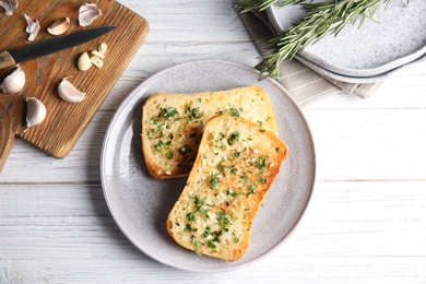 Photo of Flat lay composition with tasty garlic bread on table