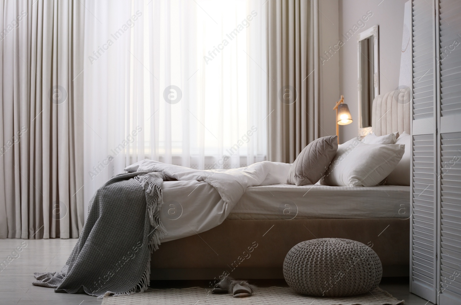 Stylish room interior with big comfortable bed Photo of Stylish room interior with big comfortable bed