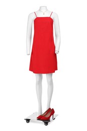 Photo of Female mannequin with necklace and shoes dressed in stylish red dress isolated on white