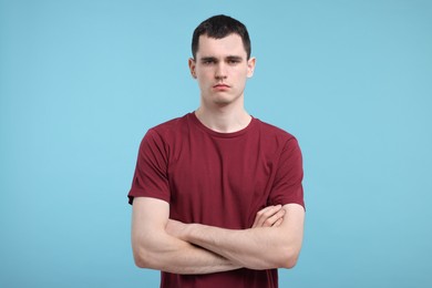 Photo of Portrait of sad man on light blue background