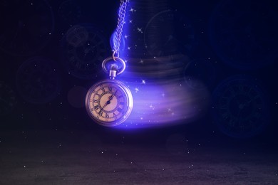Image of Hypnosis session. Vintage pocket watch with chain swinging over surface on dark background among faded clock faces, magic motion effect