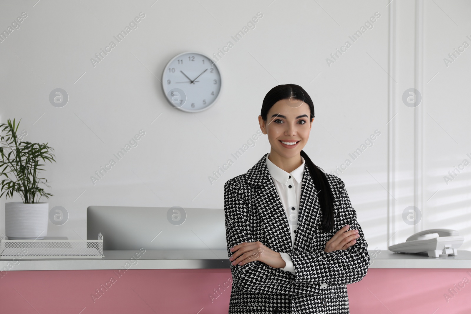 Photo of Portrait of receptionist near countertop in office, space for text