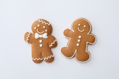 Photo of Christmas human shaped gingerbread cookies on white background, top view