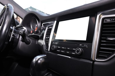 Photo of Steering wheel and dashboard inside of modern black car, closeup