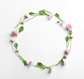 Photo of Flat lay composition with blooming daisies and space for text on white background. Spring flowers