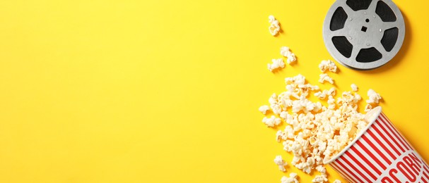 Image of Popcorn and movie reel on yellow background, space for text. Banner design