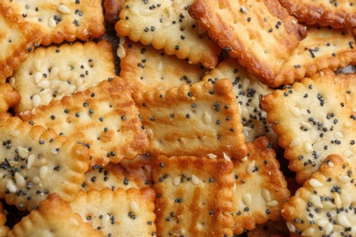 Many delicious crackers as background, closeup view