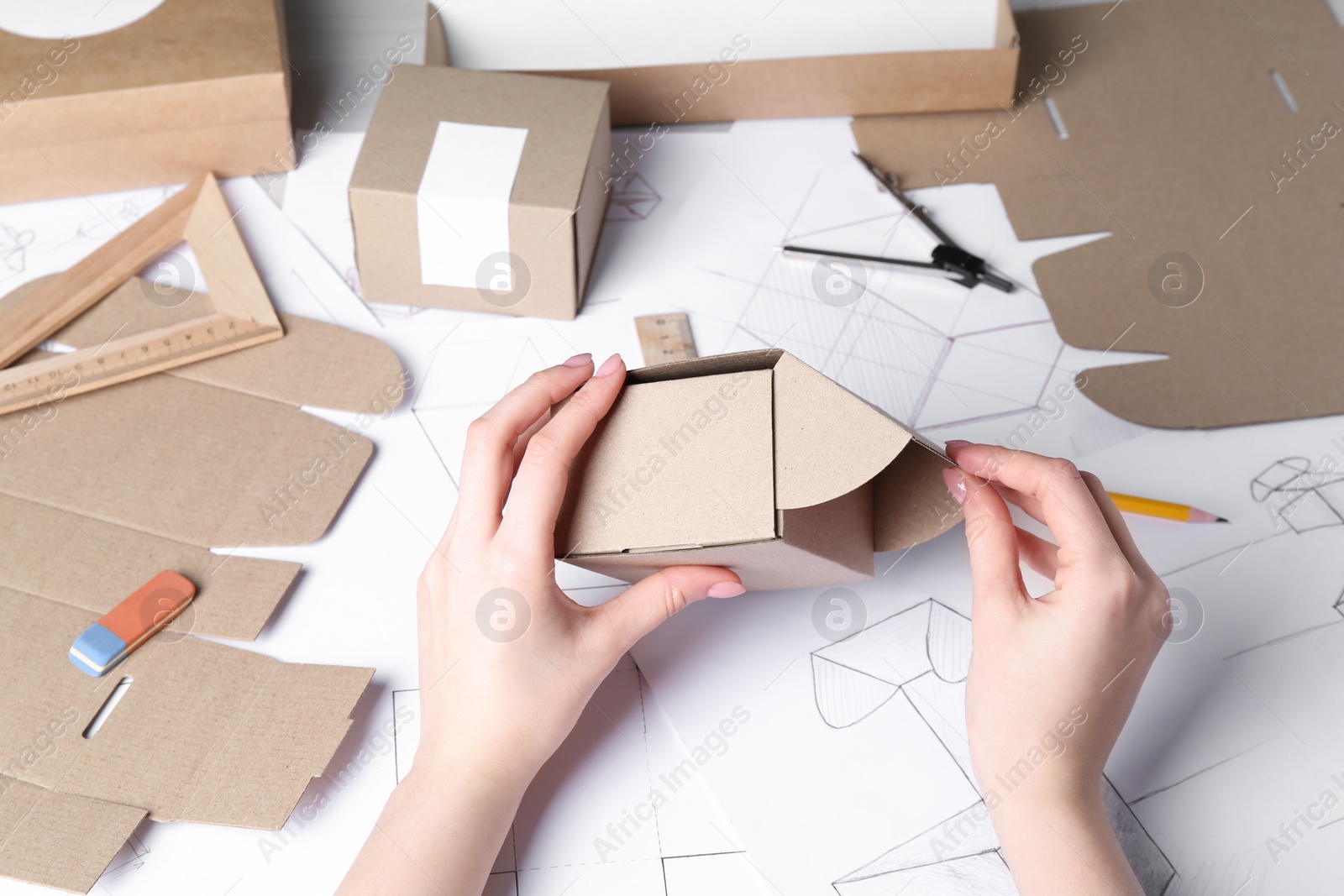 Photo of Woman creating packaging design at table, closeup