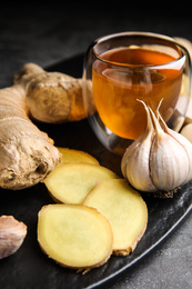 Photo of Fresh garlic and other natural cold remedies on grey table