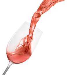 Pouring delicious rose wine into glass on white background