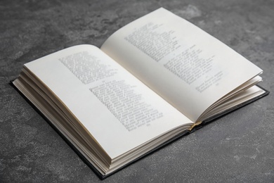 Open hardcover book on grey stone table