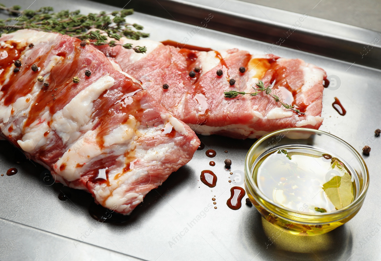 Photo of Fresh raw ribs on baking sheet, closeup