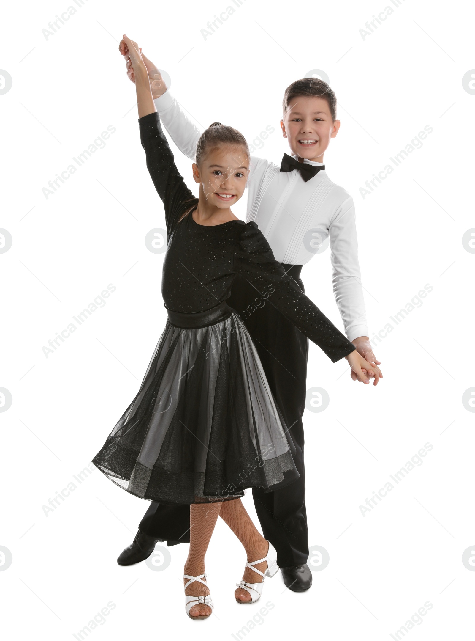 Photo of Beautifully dressed couple of kids dancing on white background