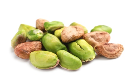 Photo of Heap of peeled organic pistachio nuts on white background, closeup