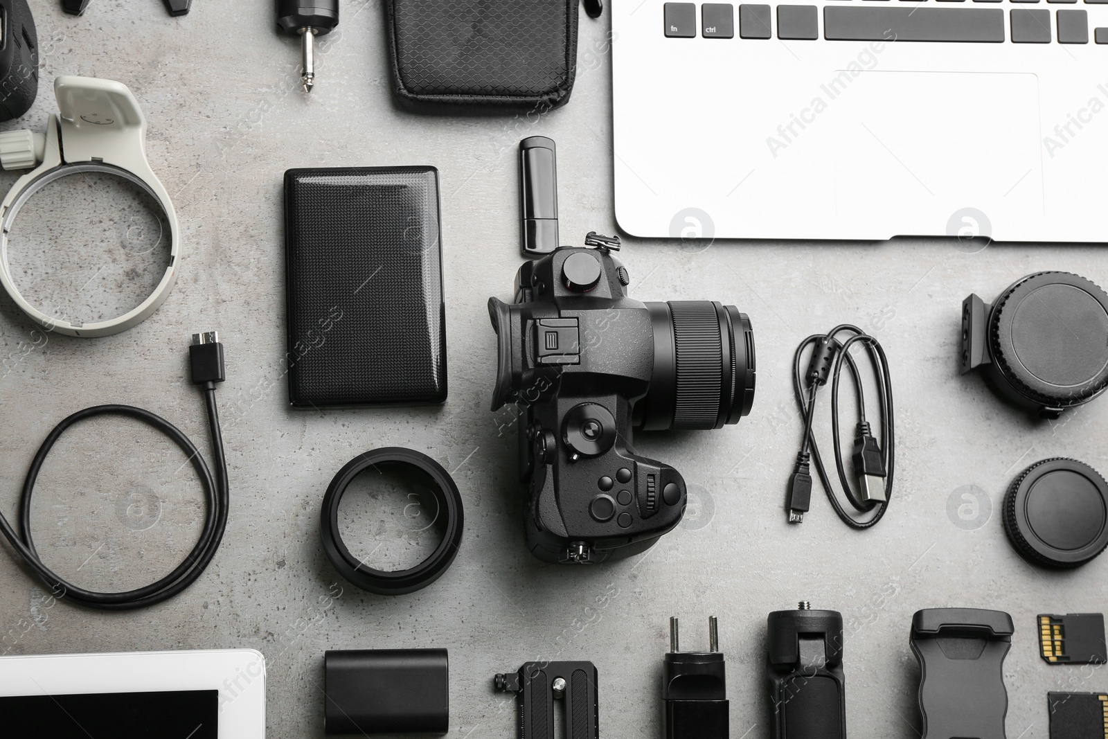 Photo of Flat lay composition with camera and video production equipment on light grey stone background