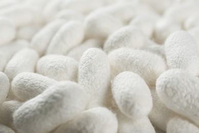 Pile of natural silkworm cocoons as background, closeup