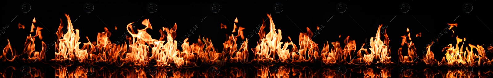 Image of Bright fire flames on black background. Banner design