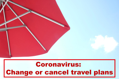 Image of Vacation cancellation concept. View of red umbrella and blue sky on sunny day 