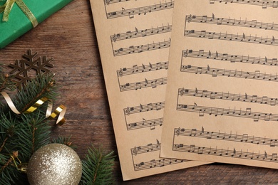 Flat lay composition with music sheets on wooden background. Christmas celebration